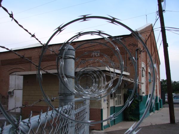 single-loop concertina wire is mounted on the fence
