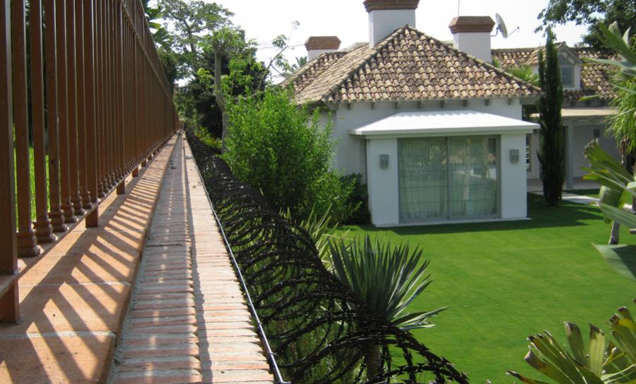 Black PVC coated concertina wire is used for residential protection